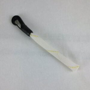 A white and black plastic handle on top of a table.