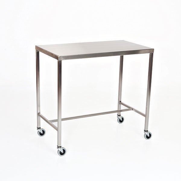 A stainless steel table with wheels on the bottom.