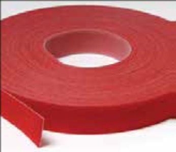 A roll of red tape on top of a table.