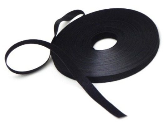 A roll of black ribbon on top of a white table.