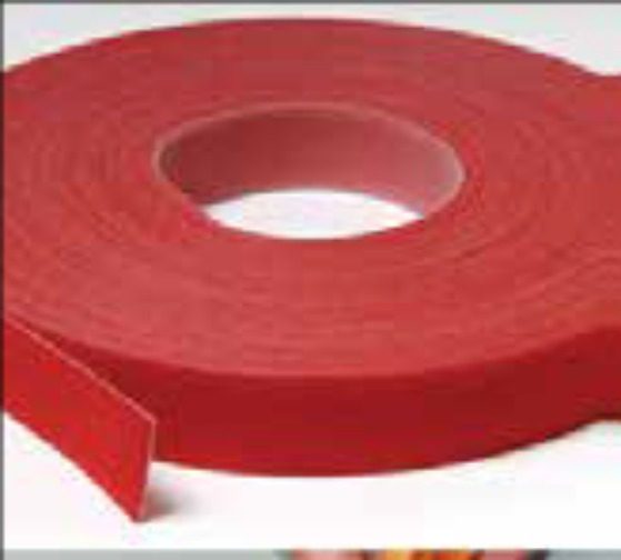 A roll of red tape on top of a table.