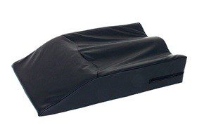 A black wedge pillow with a cover on top of it.